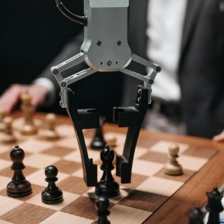 A robotic arm playing chess.