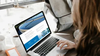 Woman working on a laptop.