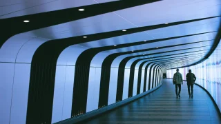 People walking through a corridor.