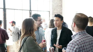 Product School | Unsplash Four people at a conference.